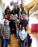 Group of diverse adults standing on wooden stairs