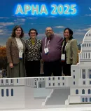 attendees at an APHA 2025 photo display featuring the U.S. Capitol