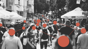 Black-and-white photo of a crowded street with red dots and connecting lines overlay, representing networks, data, and community connections